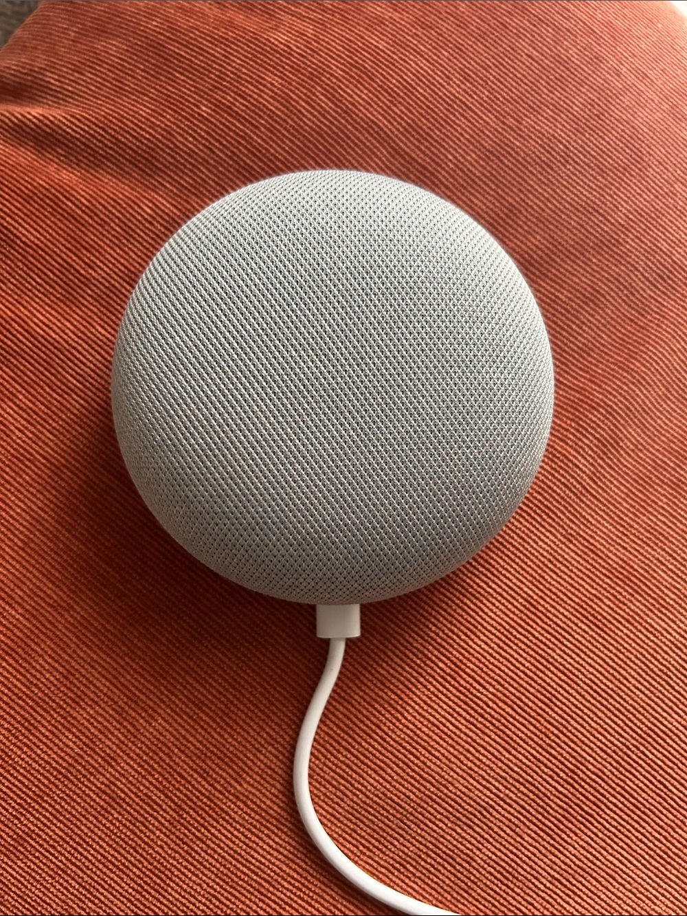 A gray google home mini smart speaker
